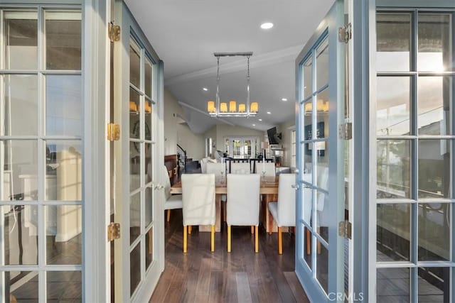 dining area featuring an inviting chandelier, dark hardwood / wood-style floors, vaulted ceiling, and french doors