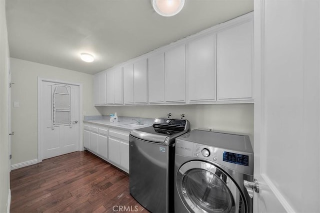 laundry room featuring cabinets, dark hardwood / wood-style flooring, sink, and independent washer and dryer