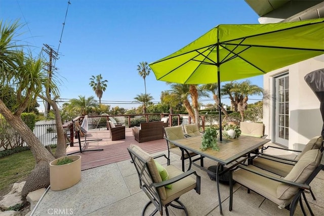 view of patio / terrace featuring an outdoor living space, a wooden deck, and french doors