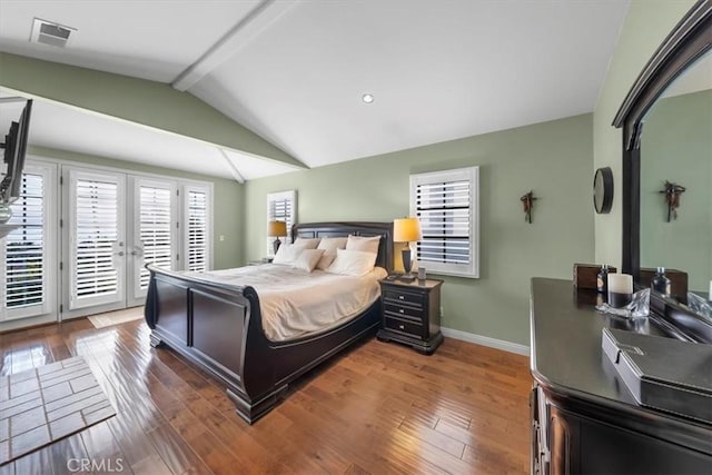 bedroom featuring french doors, access to exterior, hardwood / wood-style floors, and vaulted ceiling with beams