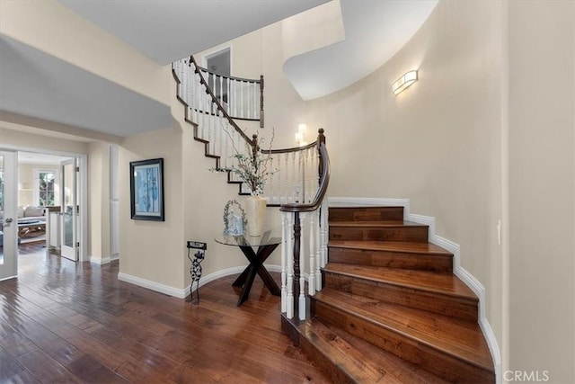 stairs with french doors and wood-type flooring