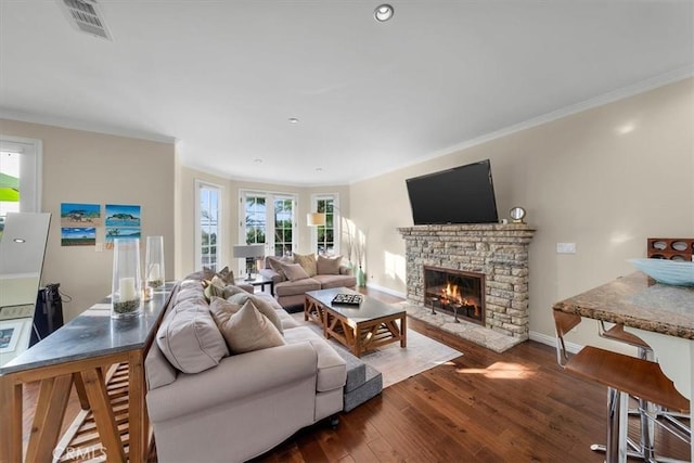 living room featuring ornamental molding, a fireplace, and dark hardwood / wood-style flooring