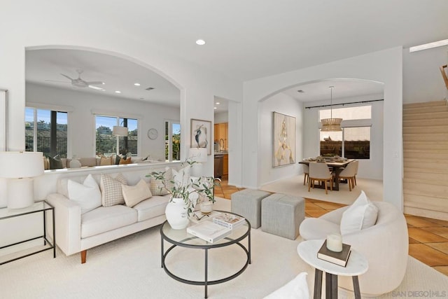 tiled living room featuring ceiling fan