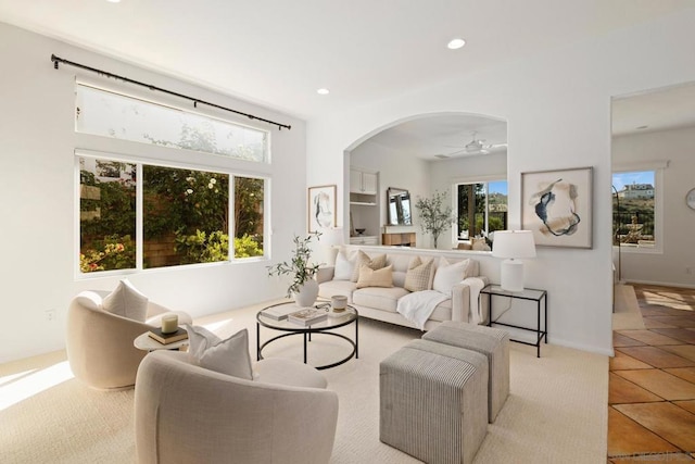 tiled living room featuring ceiling fan