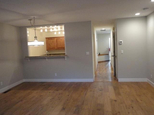 unfurnished living room featuring hardwood / wood-style flooring