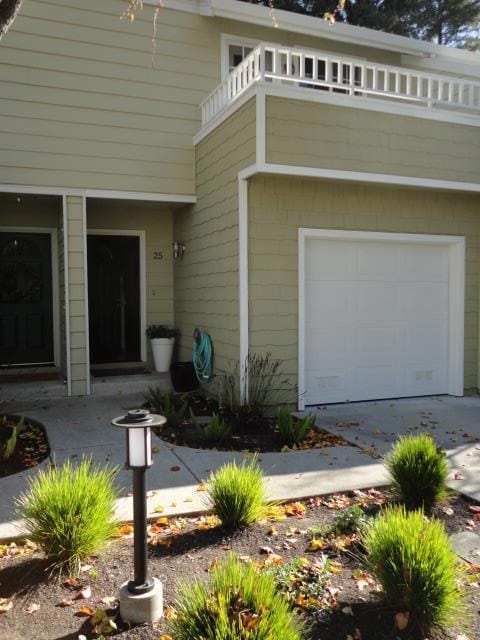 property entrance with a garage and a balcony