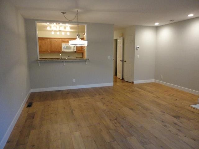 unfurnished living room featuring hardwood / wood-style flooring