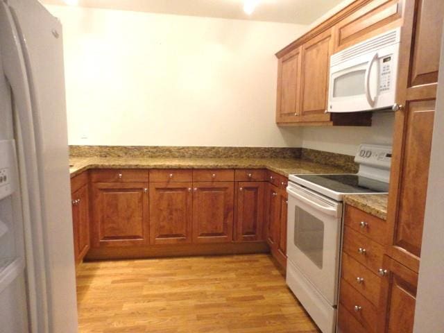 kitchen with white appliances and light wood-type flooring