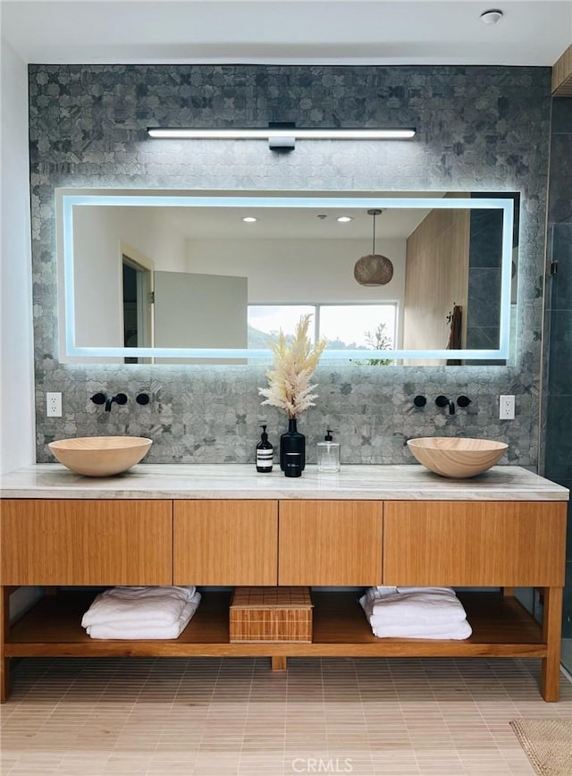 bathroom with vanity and decorative backsplash