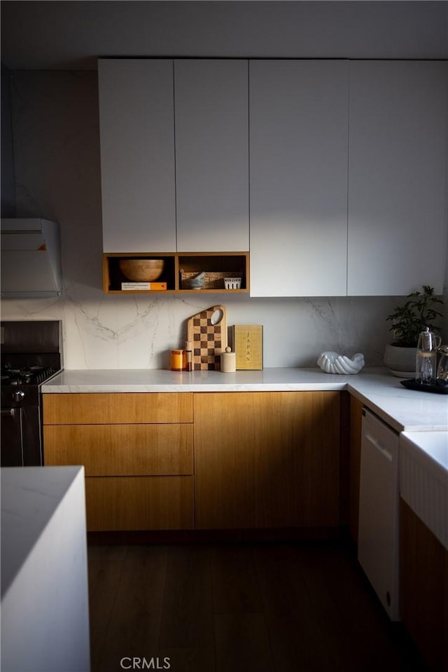 kitchen with white dishwasher, backsplash, dark wood-type flooring, and gas stove