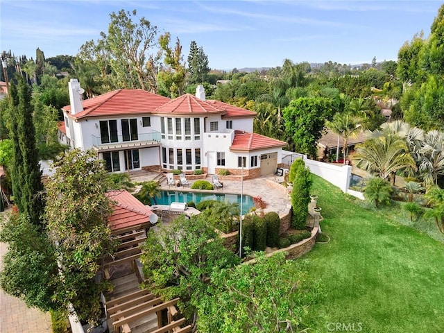 back of property featuring a yard and a patio area