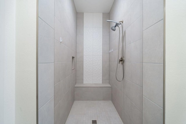 bathroom with tiled shower