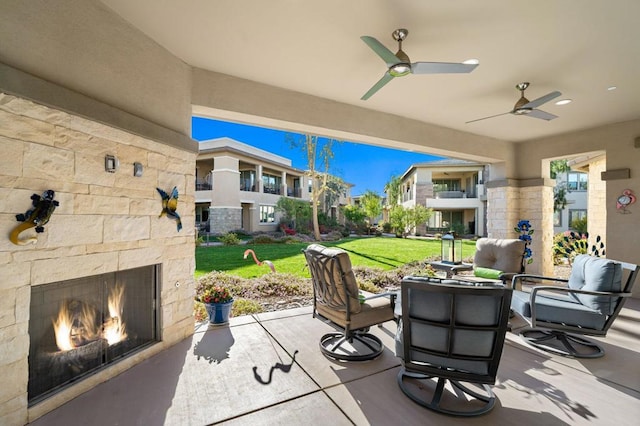 view of patio featuring ceiling fan and an outdoor stone fireplace