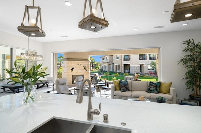 kitchen featuring hanging light fixtures and a fireplace