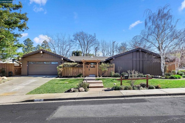 ranch-style home featuring a garage and a front lawn