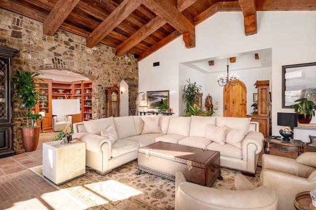 living room with beamed ceiling, high vaulted ceiling, an inviting chandelier, and wood ceiling