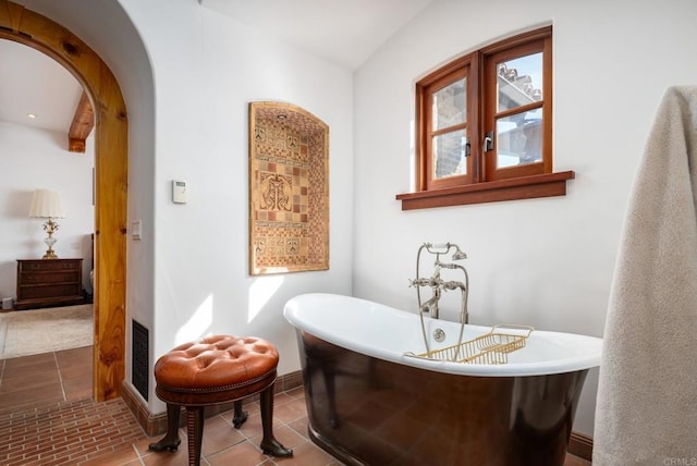 bathroom featuring a bath and tile patterned flooring