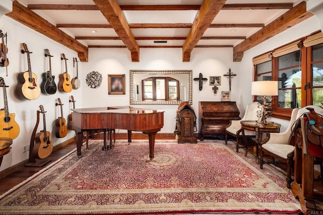 sitting room with beam ceiling and wood-type flooring