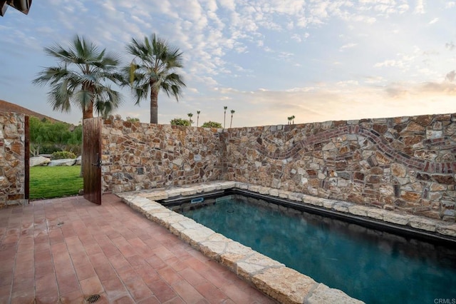 view of pool at dusk