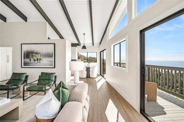 22332 Eagle Rock Way, Laguna Beach, CA 92651 - living area with beam ceiling, wood finished floors, a water view, and high vaulted ceiling