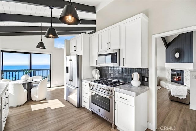 22332 Eagle Rock Way, Laguna Beach, CA 92651 - kitchen with high end appliances, tasteful backsplash, white cabinets, and light wood-style floors