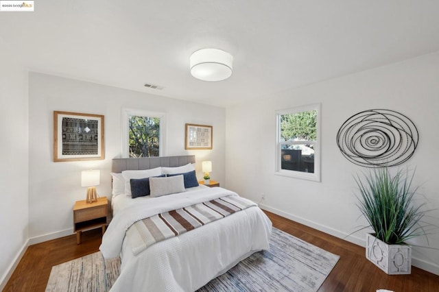 bedroom with dark hardwood / wood-style floors