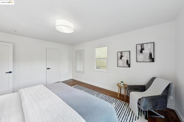 bedroom with dark wood-type flooring