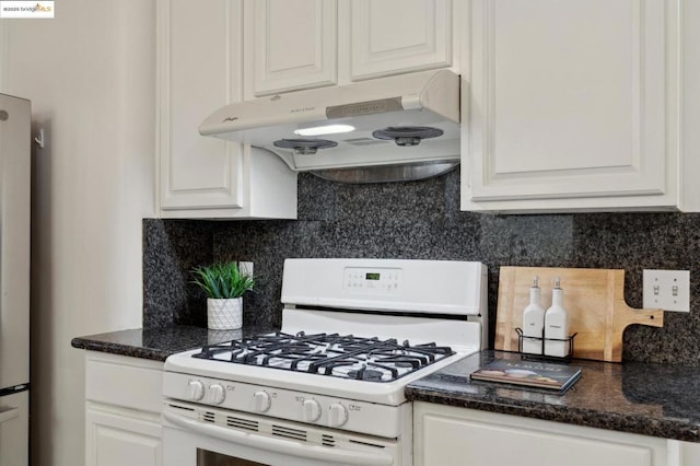 kitchen featuring backsplash, white gas stove, and white cabinets