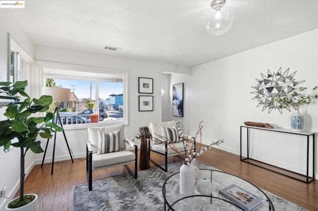 living area with hardwood / wood-style flooring