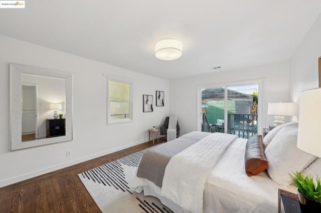 bedroom with dark hardwood / wood-style floors and access to exterior