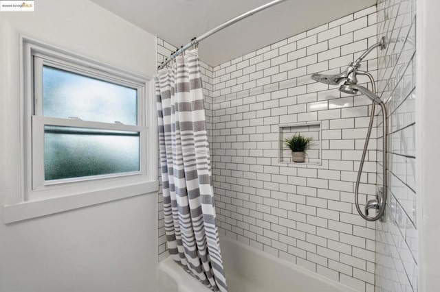 bathroom featuring shower / tub combo with curtain