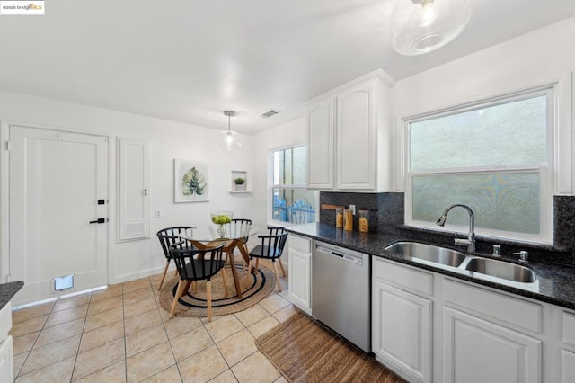 kitchen featuring light tile patterned floors, sink, dishwasher, tasteful backsplash, and white cabinets