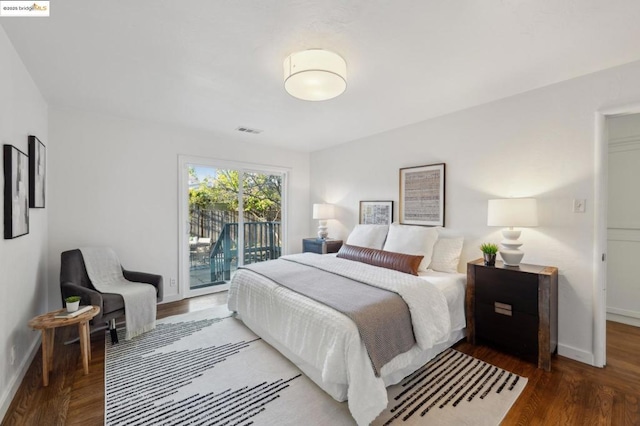 bedroom featuring access to exterior and wood-type flooring