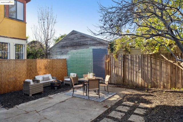 view of patio featuring an outdoor living space with a fire pit