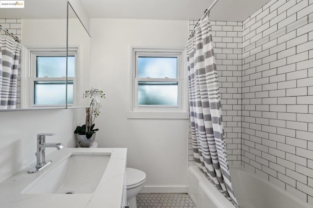 full bathroom with vanity, a healthy amount of sunlight, shower / bath combination with curtain, and toilet