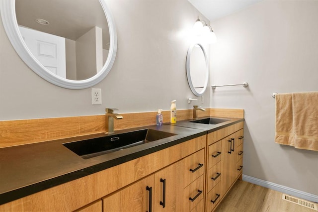 bathroom featuring vanity and hardwood / wood-style floors