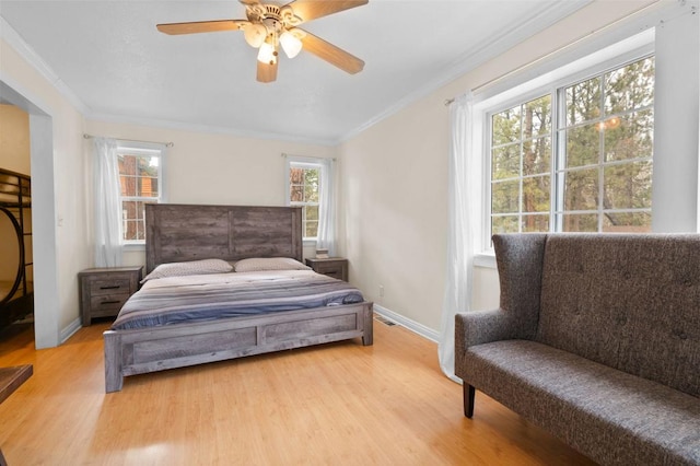 bedroom featuring ceiling fan, ornamental molding, and light hardwood / wood-style floors