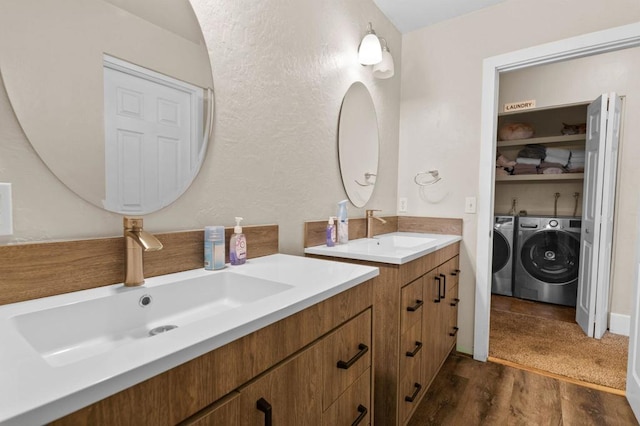 bathroom with vanity, hardwood / wood-style flooring, and independent washer and dryer