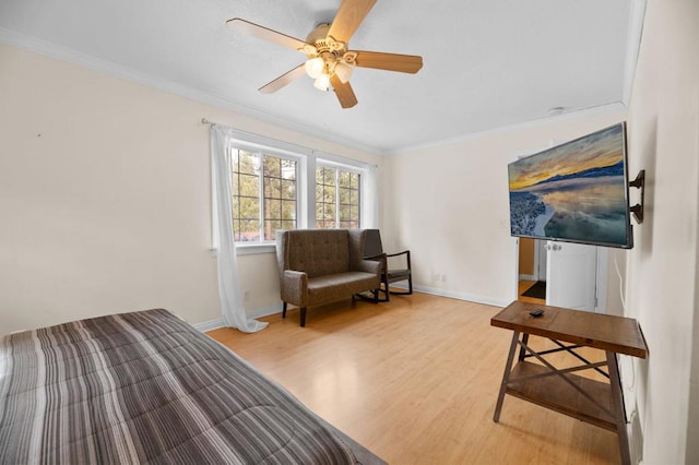 bedroom featuring ceiling fan, ornamental molding, and light hardwood / wood-style flooring