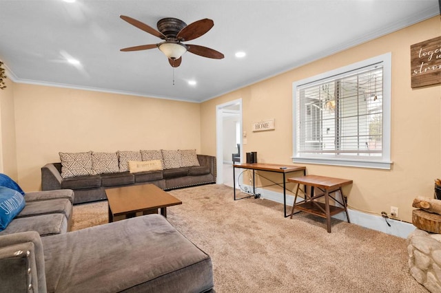 carpeted living room featuring ornamental molding and ceiling fan