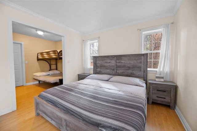 bedroom featuring crown molding and light hardwood / wood-style floors