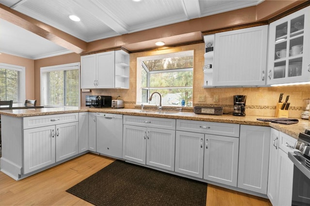 kitchen with beamed ceiling, white cabinetry, sink, and white dishwasher