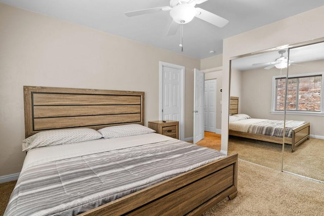 carpeted bedroom with ceiling fan and a closet