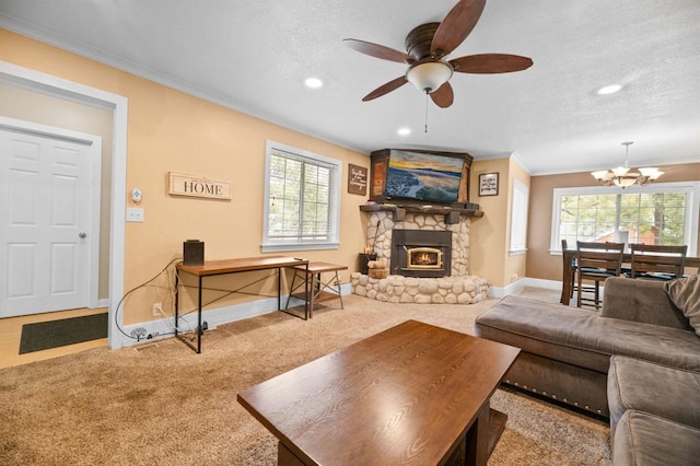 carpeted living room featuring crown molding, a healthy amount of sunlight, a fireplace, and a textured ceiling