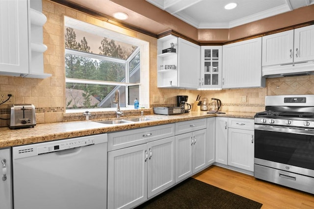 kitchen with white dishwasher, sink, white cabinetry, and stainless steel gas range oven