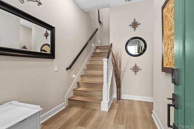 stairs featuring hardwood / wood-style flooring