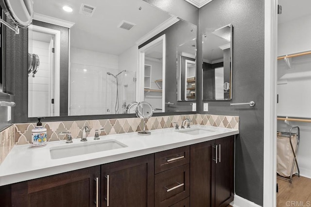 16750 Coyote Bush Dr Unit 107, San Diego, CA 92127 - bathroom featuring decorative backsplash, visible vents, a sink, and a tile shower