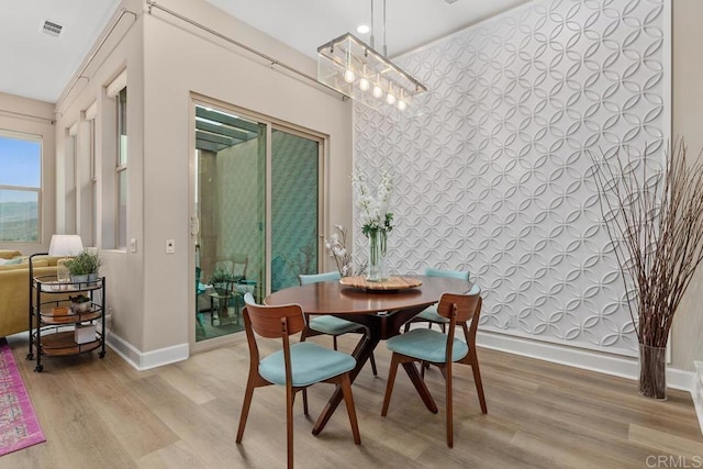 16750 Coyote Bush Dr Unit 107, San Diego, CA 92127 - dining area with baseboards, light wood-style flooring, and visible vents