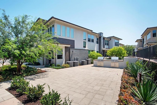 16750 Coyote Bush Dr Unit 107, San Diego, CA 92127 - exterior space with central AC unit, grilling area, exterior kitchen, and fence