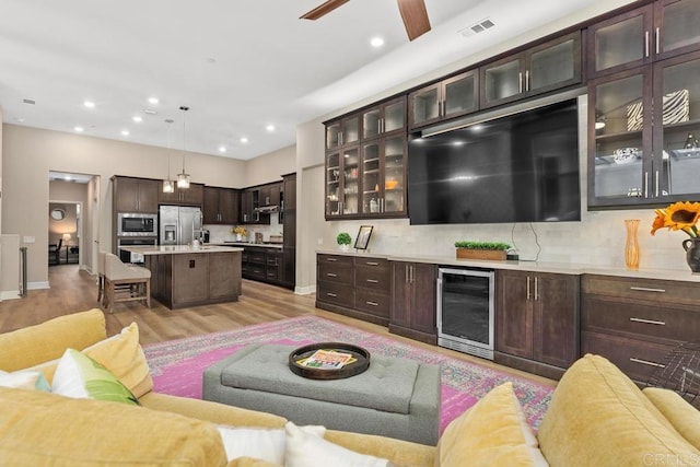 16750 Coyote Bush Dr Unit 107, San Diego, CA 92127 - living area featuring recessed lighting, wine cooler, light wood-style floors, visible vents, and a ceiling fan